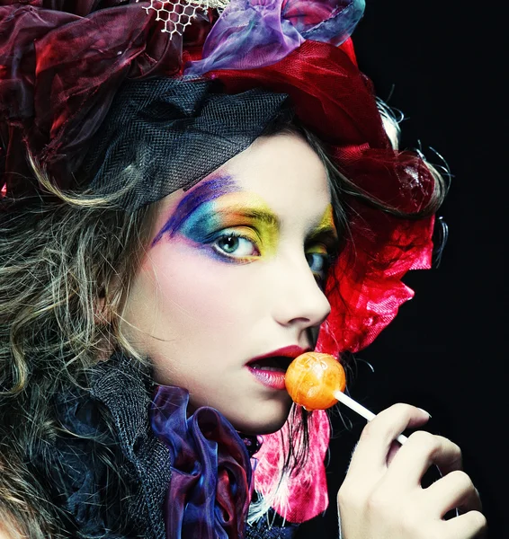 Girl with  with creative make-up holds  lollipop — Stock Photo, Image