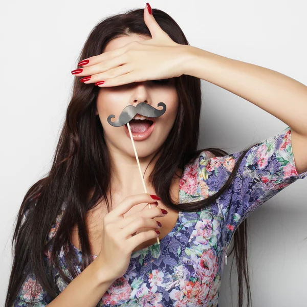 Young woman wearing fake mustaches. — Stock Photo, Image