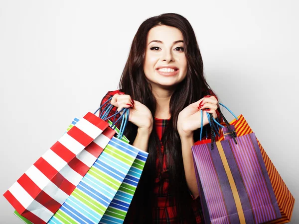 Portrait of young happy smiling woman with shopping bags — Stock Photo, Image