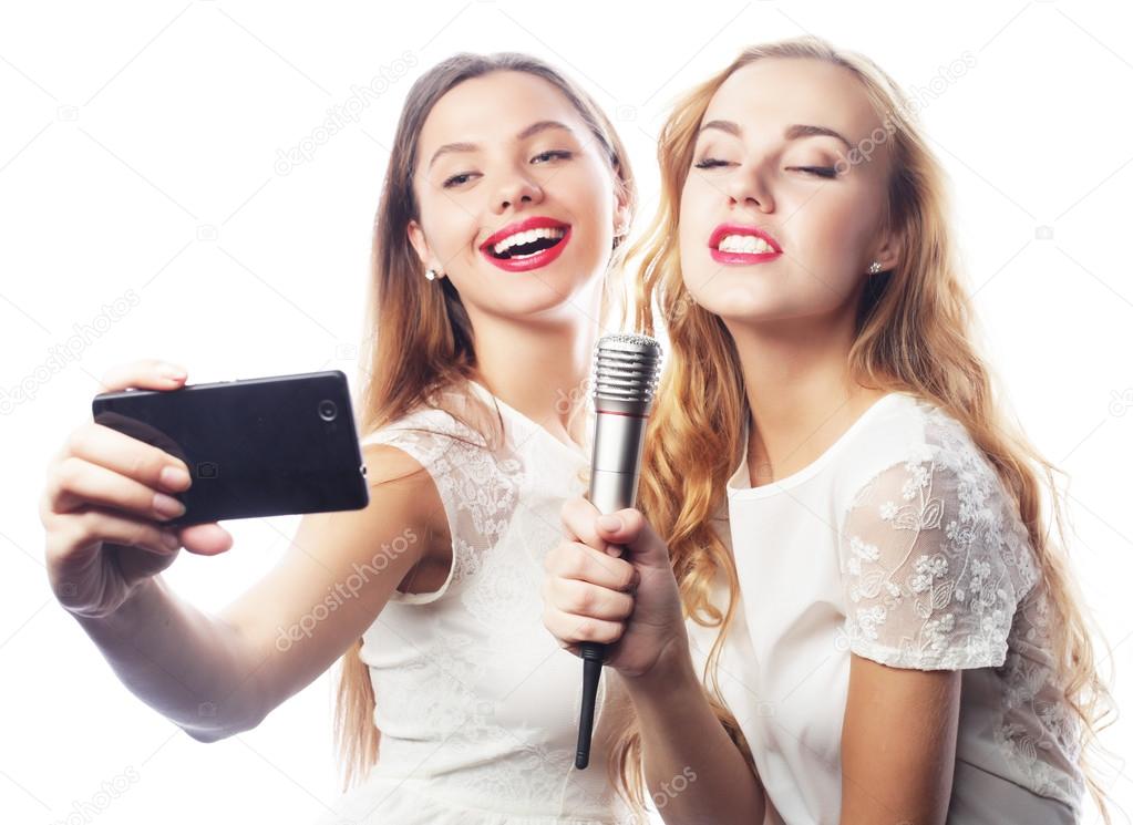 beauty  girls with a microphone singing and make selfie