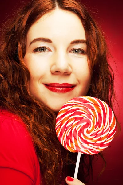 Pretty young woman holding lolly pop. — Stock Photo, Image