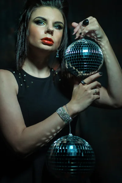 Stock image Beautiful young sensual woman holding disco ball