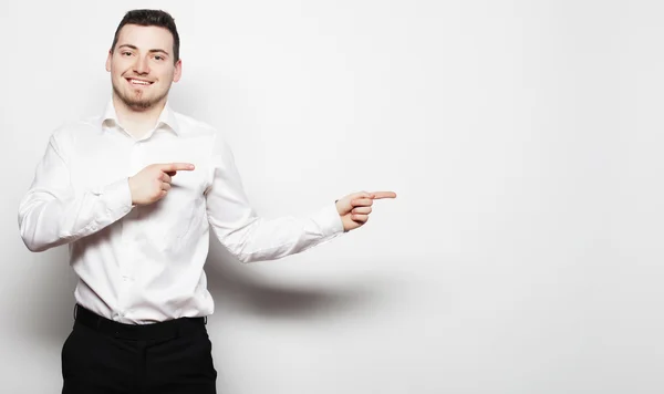 Business man points with fingers in the right side — Stock Photo, Image