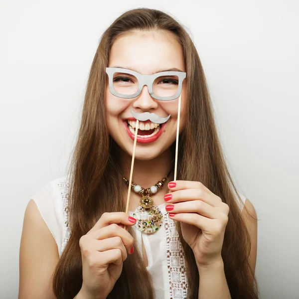 Woman holding mustache and glasses on a stick — Stock Photo, Image