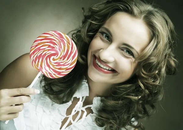 Lollipop in hand. Beautiful  girl with  candy. — Stock Photo, Image