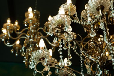 Beautiful vintage crystal chandelier in a room clipart