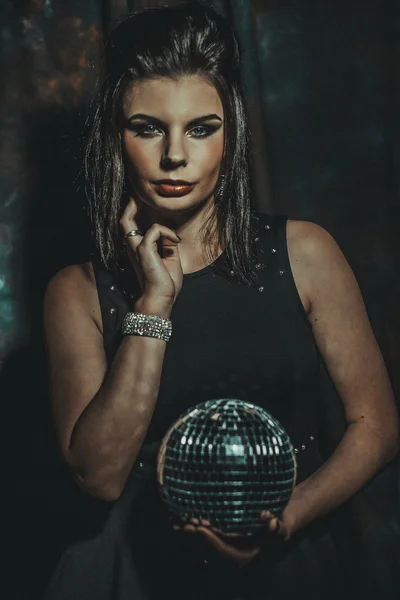 Beautiful young sensual woman holding disco ball — Stock Photo, Image