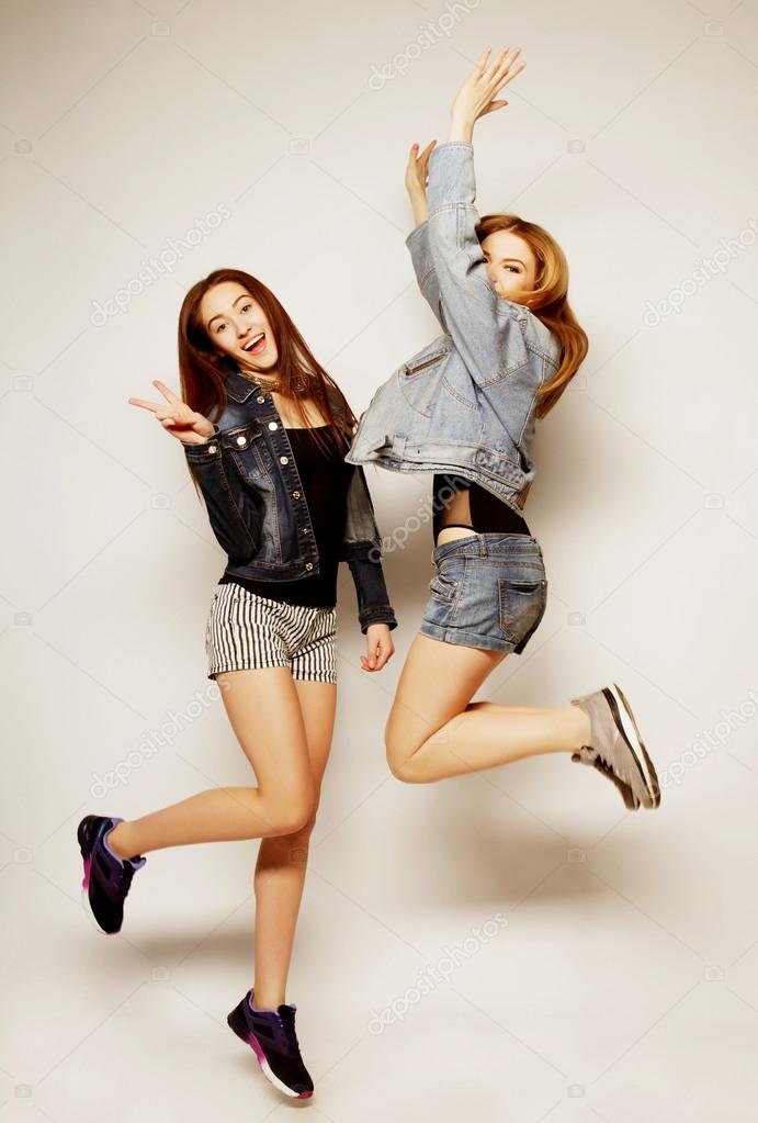 young hipster girls best friends jump