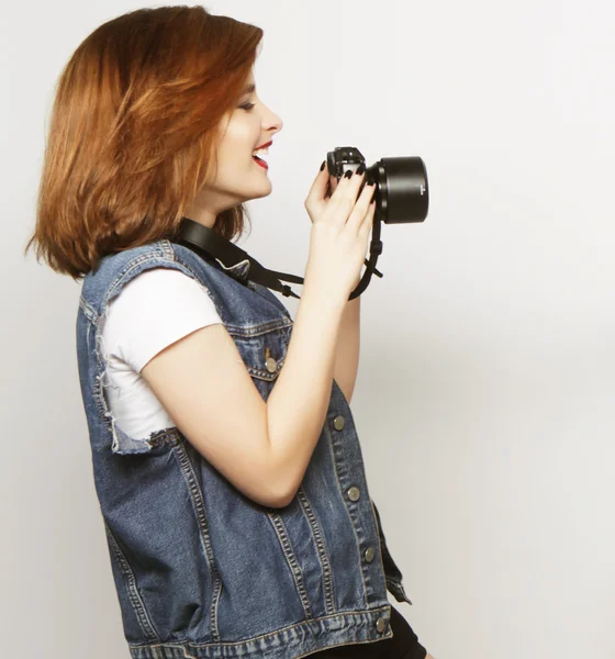 Beautiful young woman with camera — Stock Photo, Image