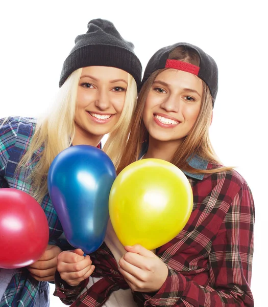 Hipster girls smiling and holding colored balloons — Stock Photo, Image