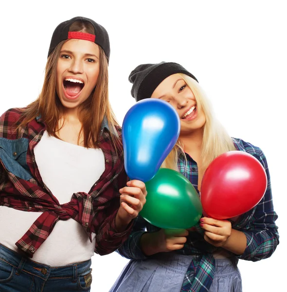 Hipster girls smiling and holding colored balloons — Stock Photo, Image