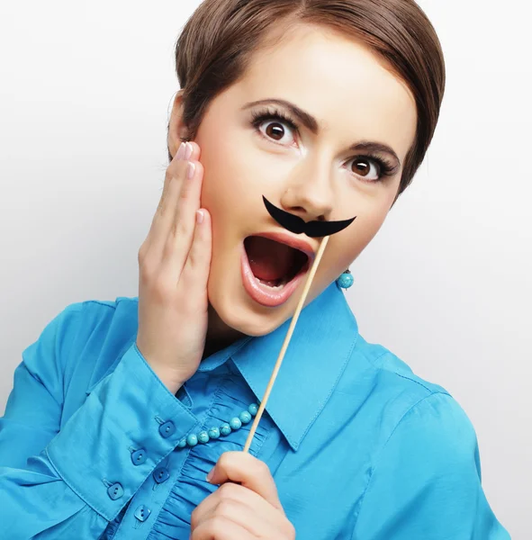 Girl wearing fake mustaches. — Stock Photo, Image