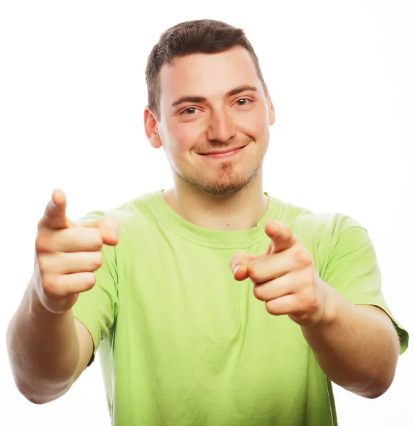 Young smiling happy man shows something — Stock Photo, Image