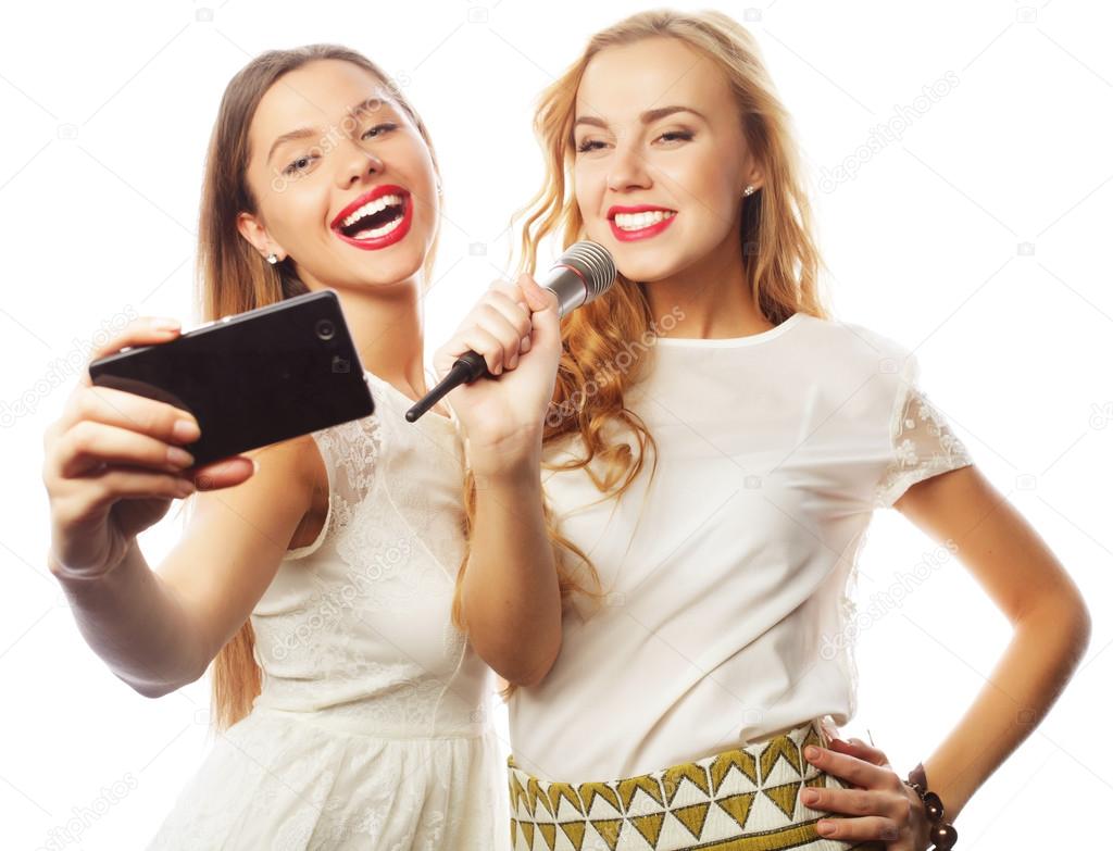 beauty  girls with a microphone singing and make selfie