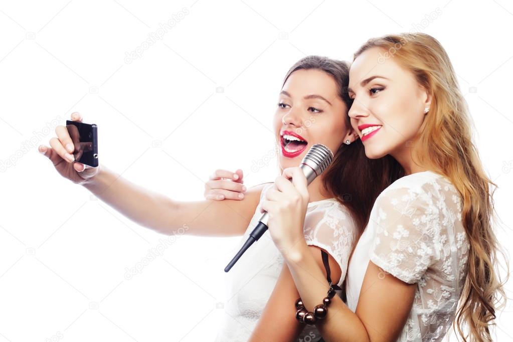 beauty  girls with a microphone singing and make selfie