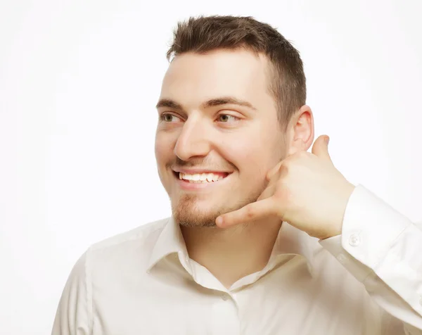 Hombre gestos de teléfono móvil cerca de su cara — Foto de Stock