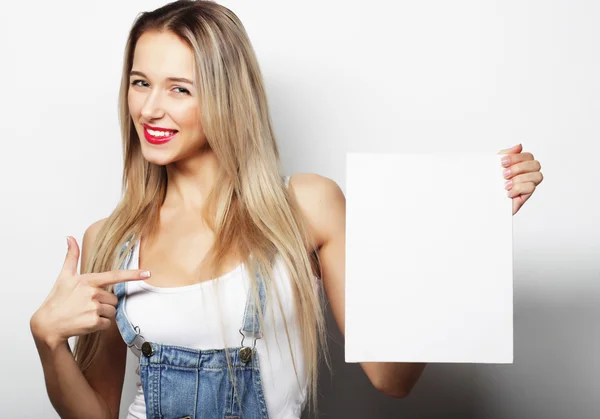 Smiling young casual style woman showing blank signboard — Stock Photo, Image