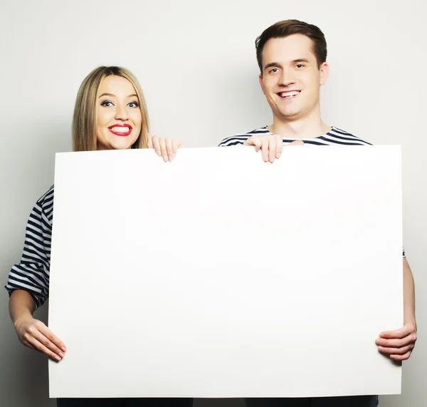 Couple holding a banner — Stock Photo, Image