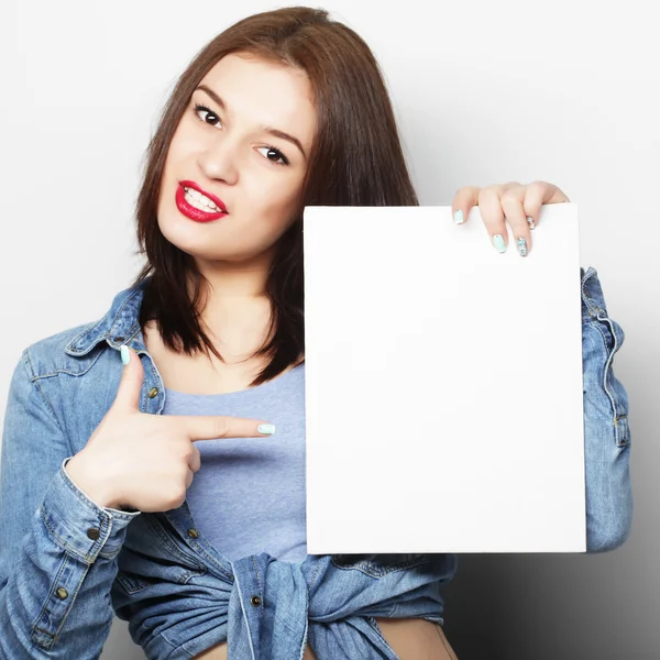 Smiling young casual style woman showing blank signboard — Stock Photo, Image