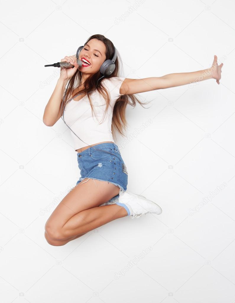 woman jumping and singing
