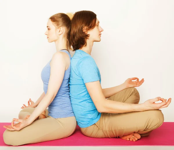 Young couple in yoga pose — Stock Photo, Image