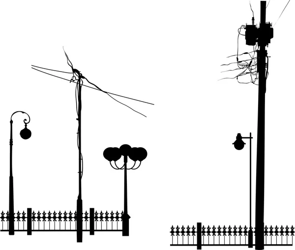 Straßenlaternen neben Zäunen — Stockvektor