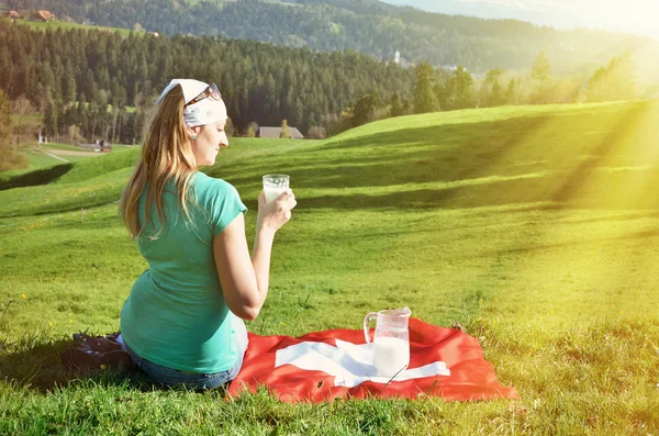 Girl with glass and jug of milk — Stock Photo, Image