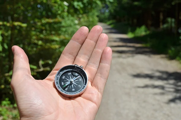 Compass in hand of male tourist — Stock Photo, Image