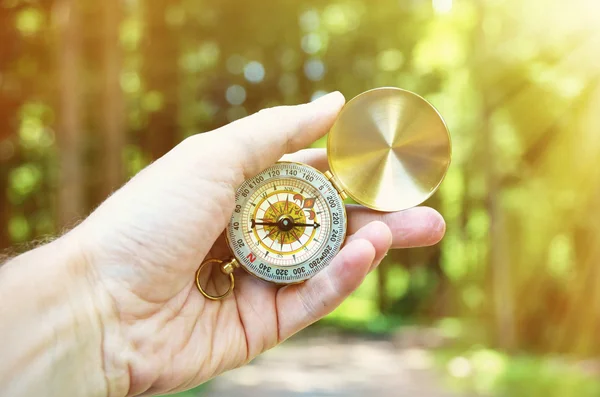Compass in hand of male tourist — Stock Photo, Image