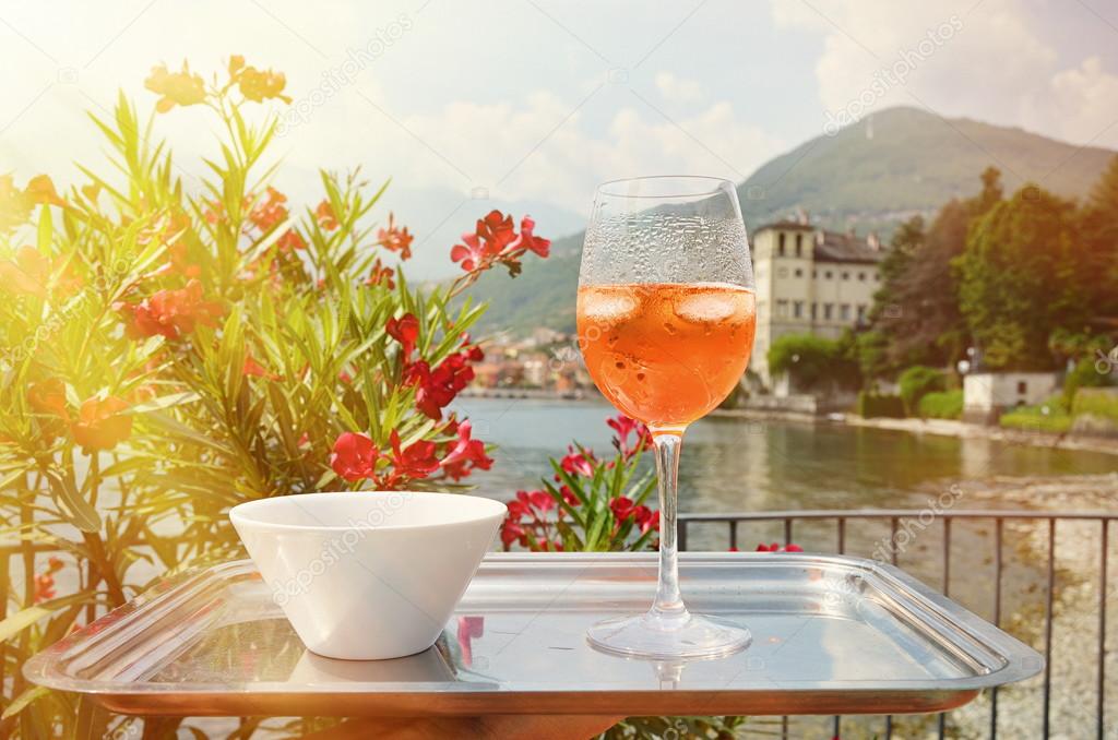 Italian Spritz cocktail against lake Como