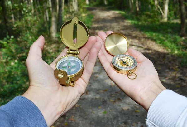 Two compasses in hands — Stock Photo, Image