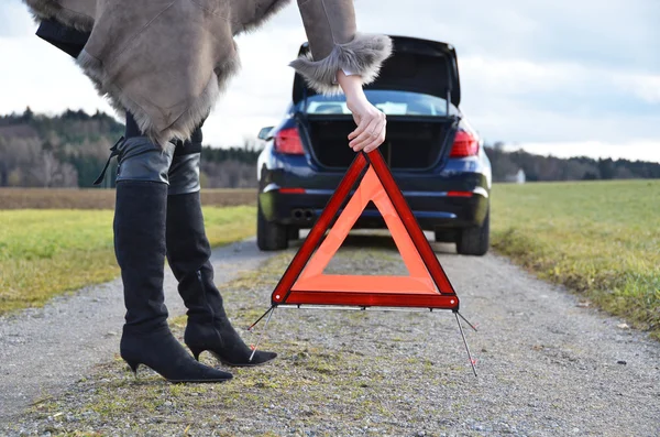 Girl and warning triangle — Stock Photo, Image