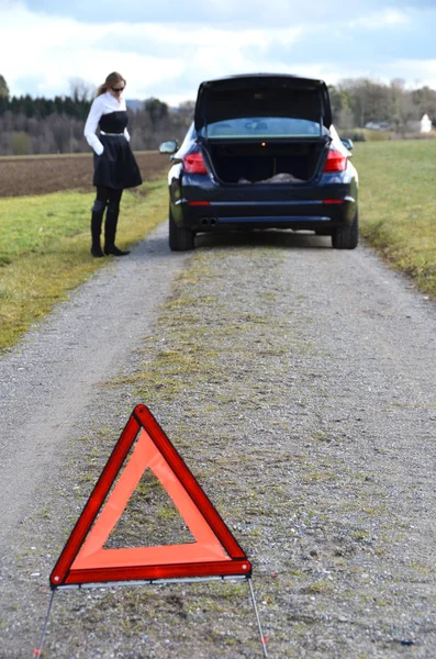 Girl and warning triangle — Stock Photo, Image