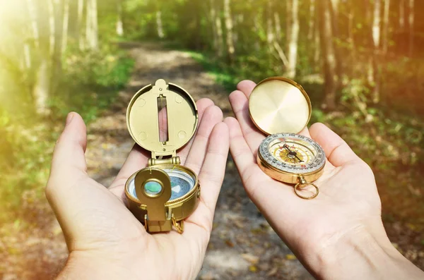 Man and woman holding compasses — Stock Photo, Image