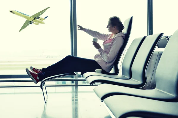 Girl at airport window — Stock Photo, Image