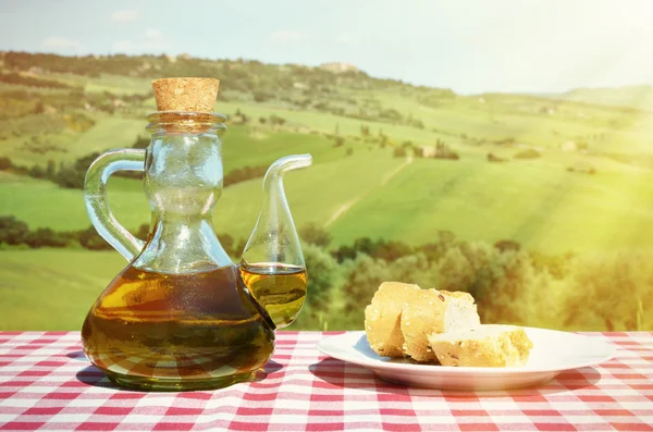 Olive oil and bread in  Tuscan landscape. — Stock Photo, Image