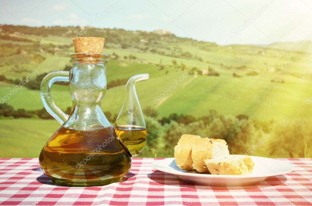 Olive oil and bread in  Tuscan landscape.