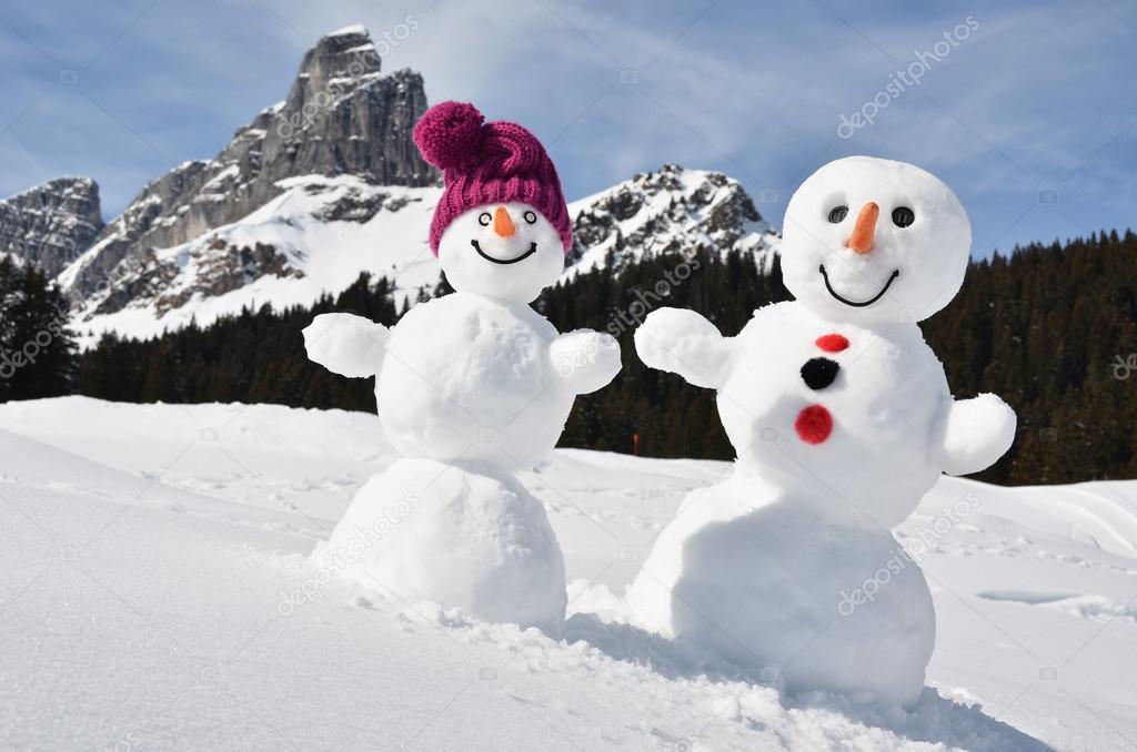 snowmen against Swiss Alps