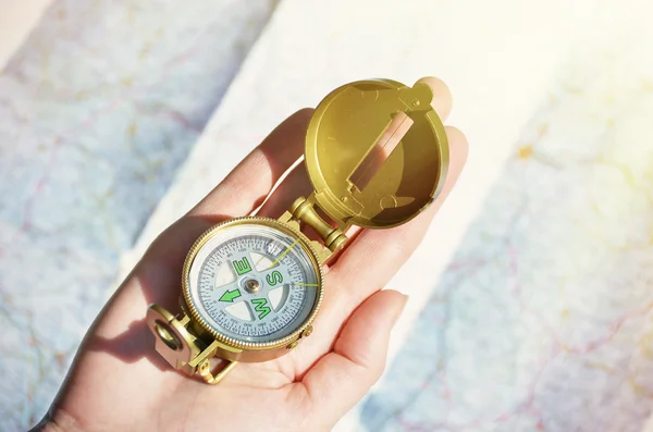 Compass in  hand against  map Stock Photo