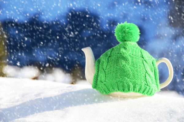 Tea pot in the knitted cap — Stock Photo, Image