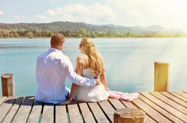 Couple on wooden jetty — Stock Photo, Image