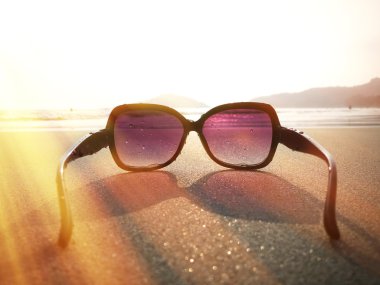 Sunglasses on sand of Palolem beach clipart