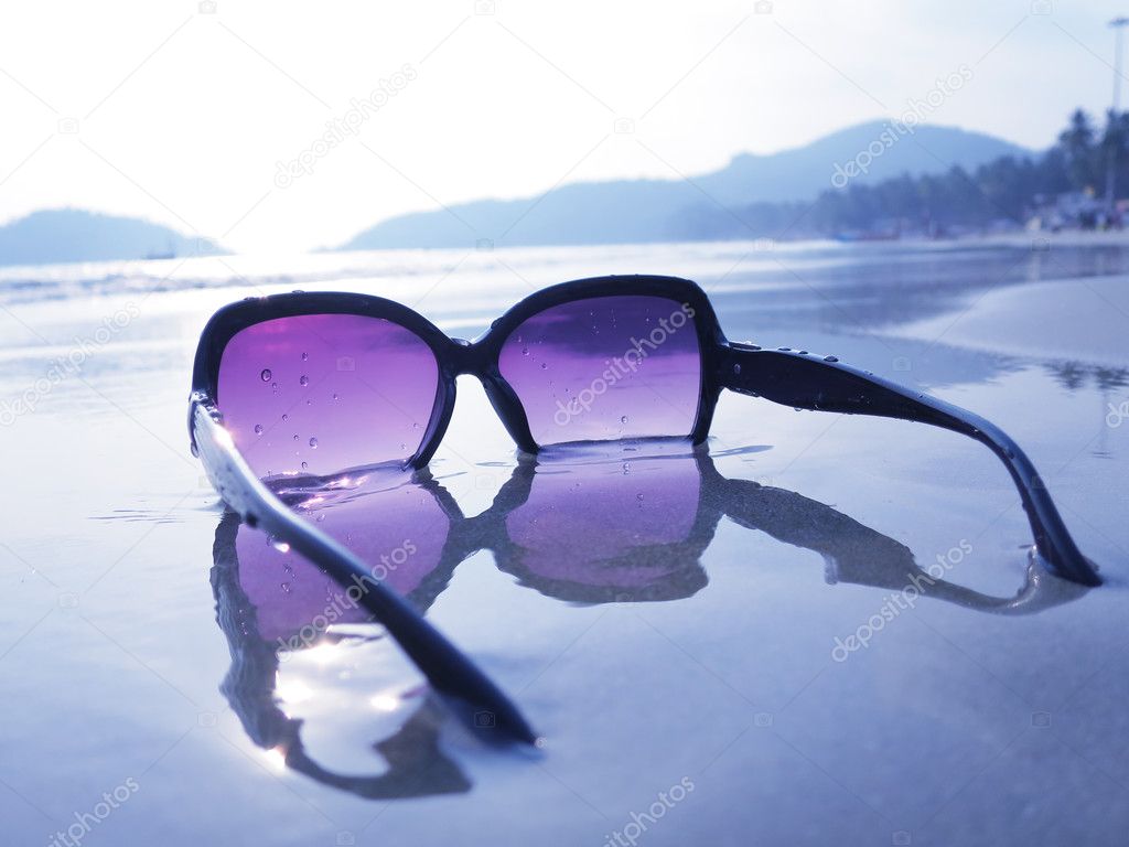 Sunglasses on sand of Palolem beach
