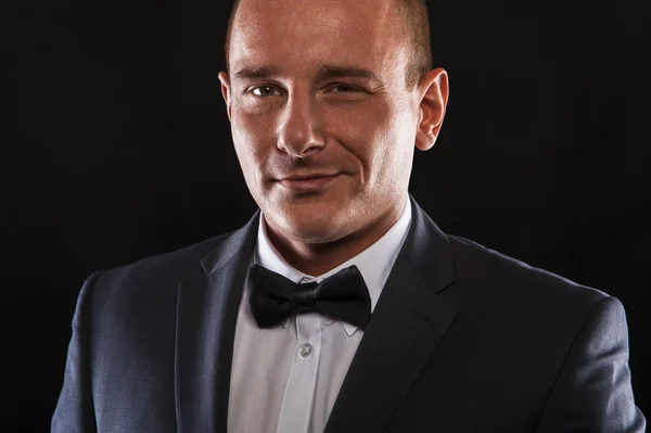 Portrait of handsome stylish man in elegant black suit — Stock Photo, Image