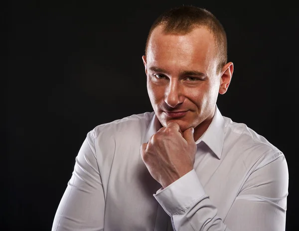 Young man thinking with finger near his face smiling. — Stock Photo, Image