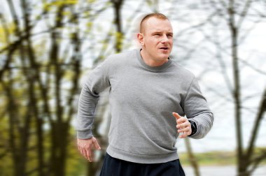 Nehir kenarında koşan adam. Açık koşucu. Mevsimlik arka plan.