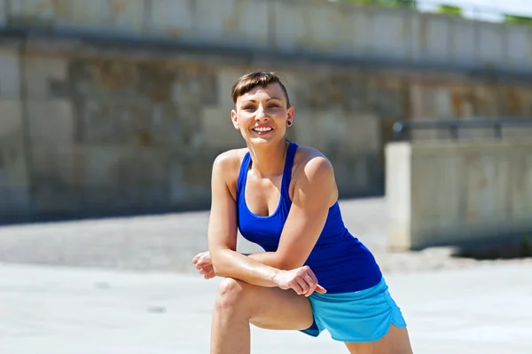 Mulher que se estende depois, antes de correr . — Fotografia de Stock