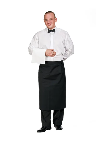 Mężczyzna kelner aprone stojący na tle izolacji. Uśmiechający się. — Zdjęcie stockowe