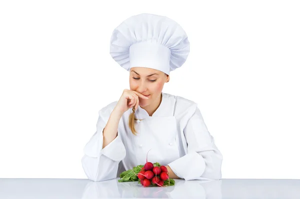 Wanita koki. Terisolasi di atas latar belakang putih oleh tabel dengan sayuran — Stok Foto