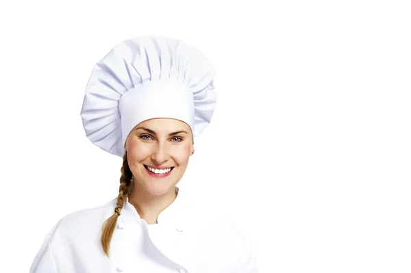 Eine junge Köchin mit traditionellem Hut und Mantel. — Stockfoto